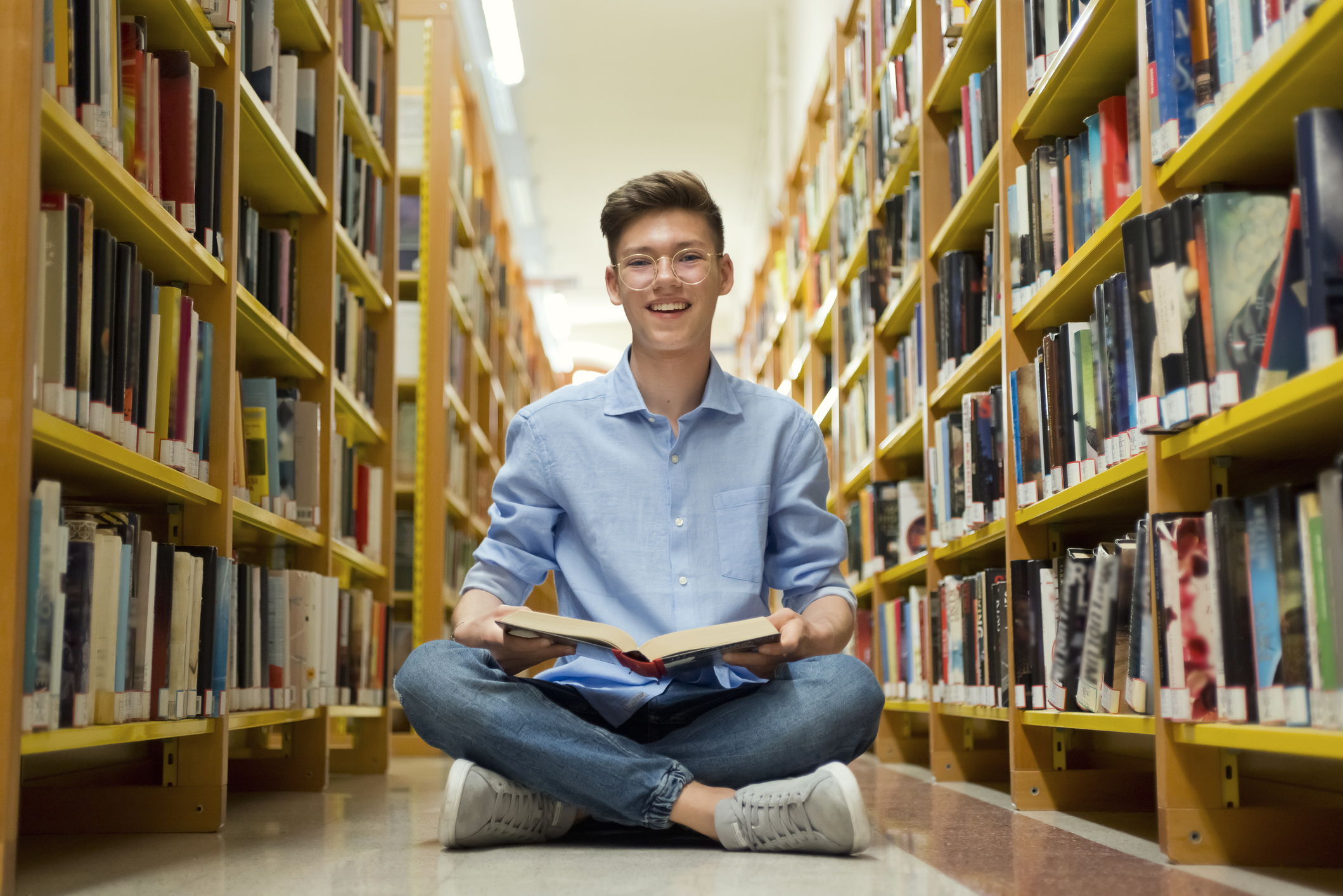 Smiling Teenage boy in library